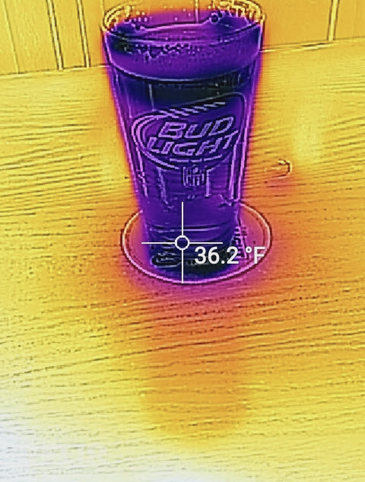 A photo from a Google review of a bar showing the thermal properties of a perfectly chilled beer, 36.2 °F.