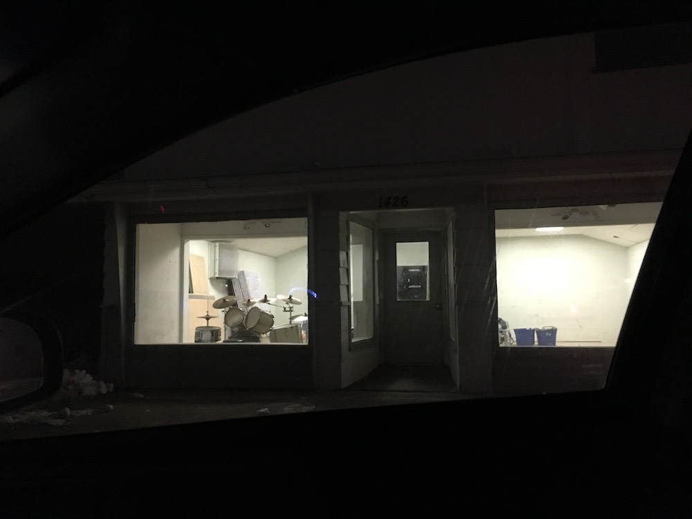 The storefront with the drums in the window.